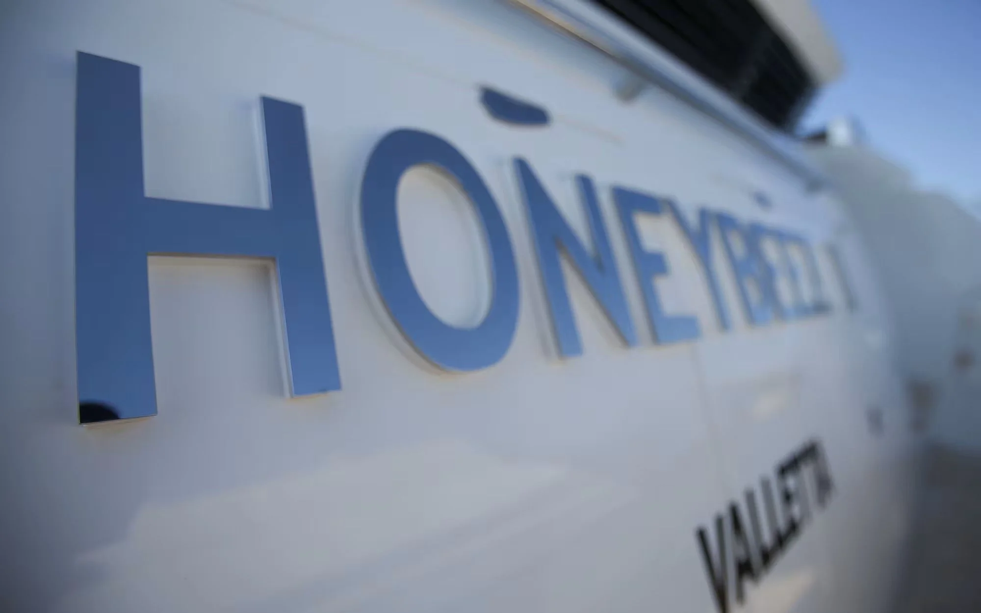 Close-up of a law enforcement vehicle with the word 'HONEY' in blue letters on the side.