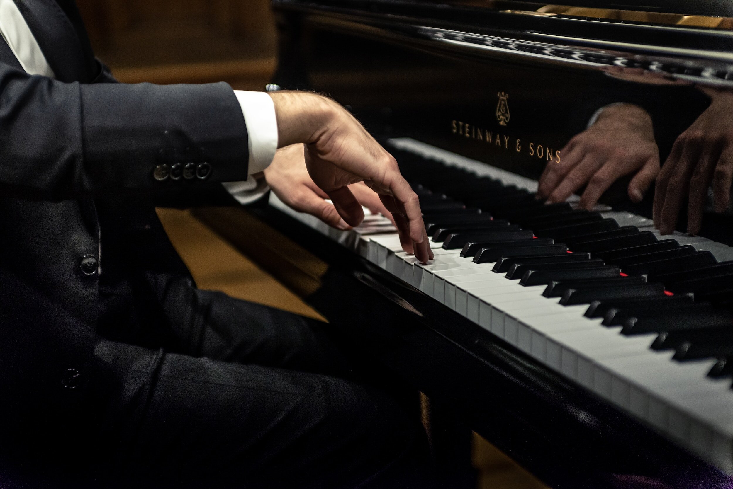 Adult piano student performing on a grand piano Steinway & Sons