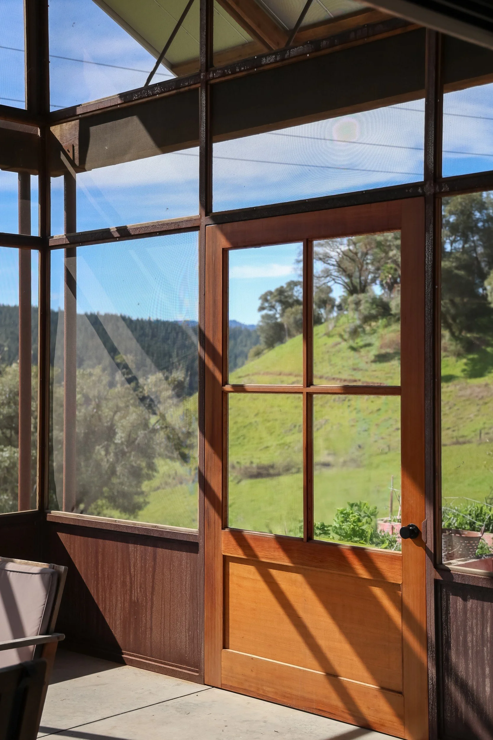 screened-porch-wood-door-hillside-view-anderson-valley-boonville-residence-72dpi.jpg