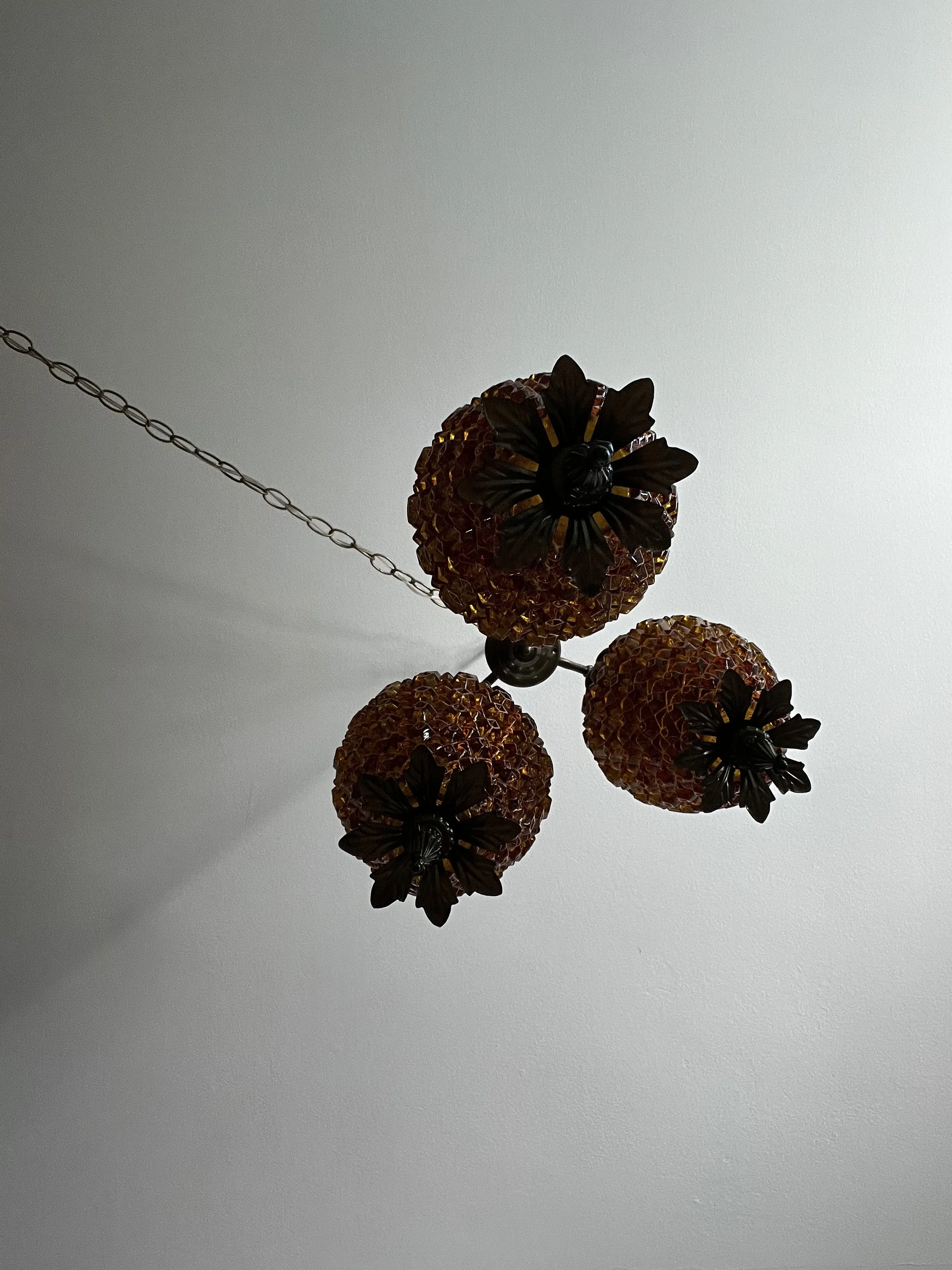 Underside view of the three-tier hanging lamp with the lights off, showing the arrangement of all three shades.