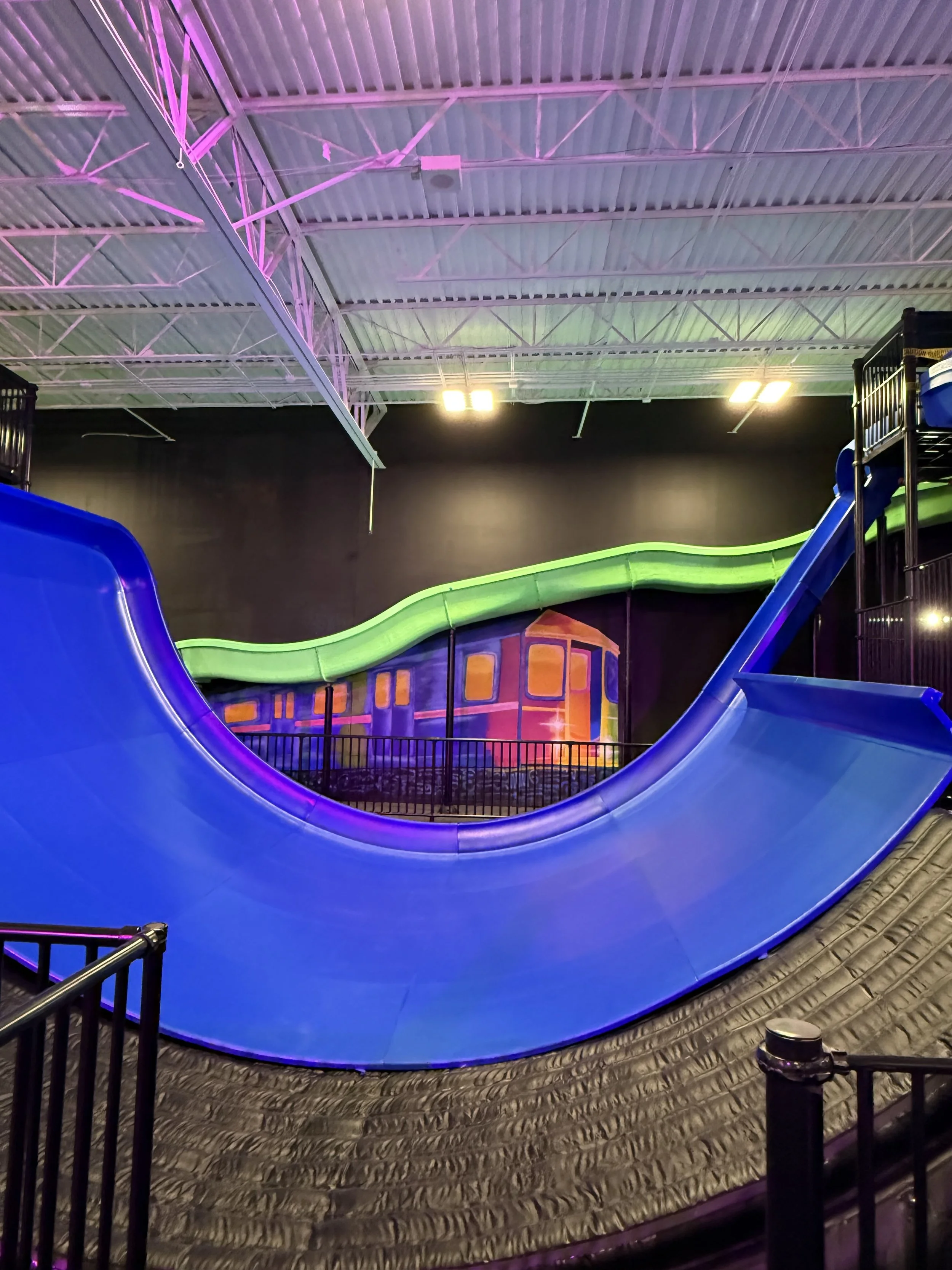 Indoor amusement park mural of a glow in the dark train