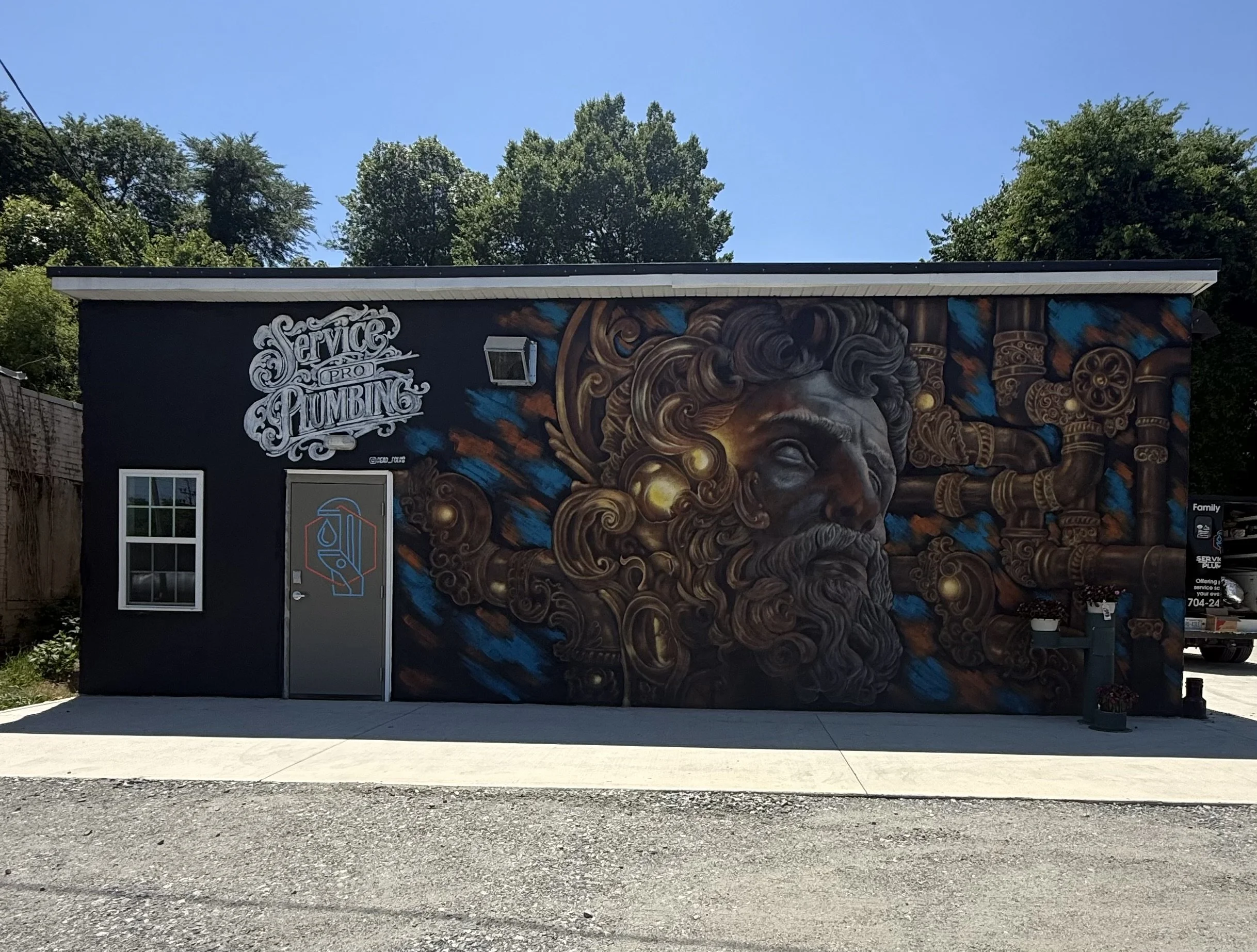 Custom mural painted on a commercial building for a plumbing company