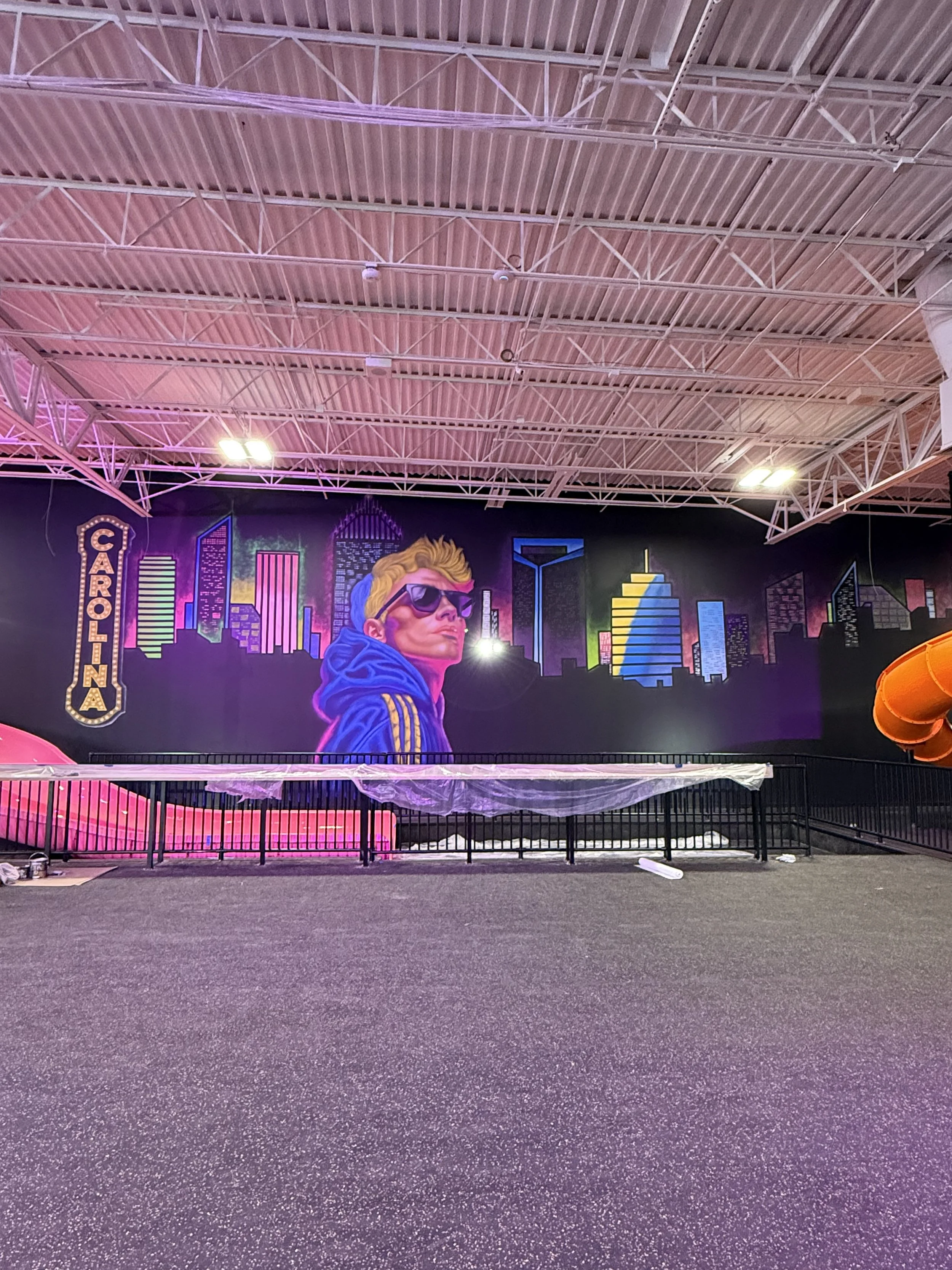 Large interior mural for Indoor amusement park contains glow in the dark features, franchise business
