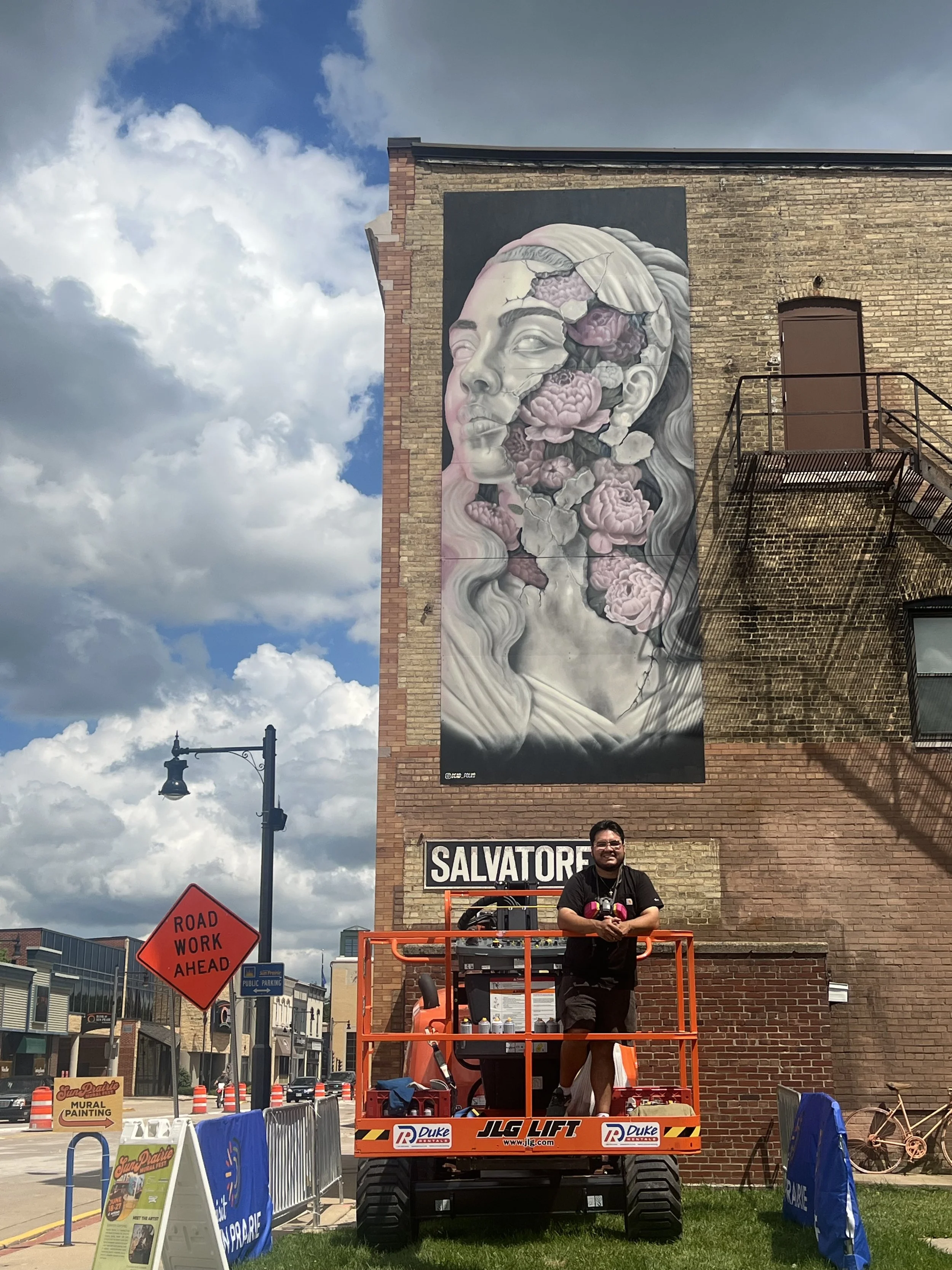 Mural of a Greek statue and floral painted in Sun prairie Wisconsin mural festival by Dead Folks murals