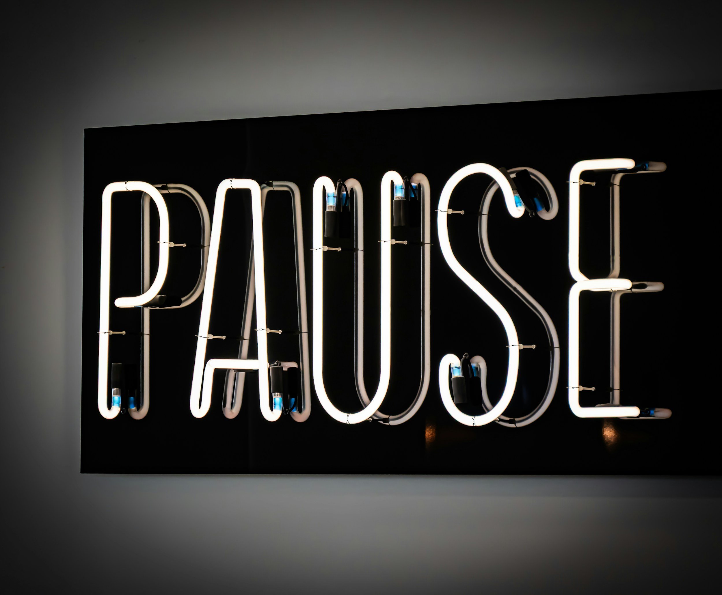 Illuminated pause sign representing the need to slow down during burnout