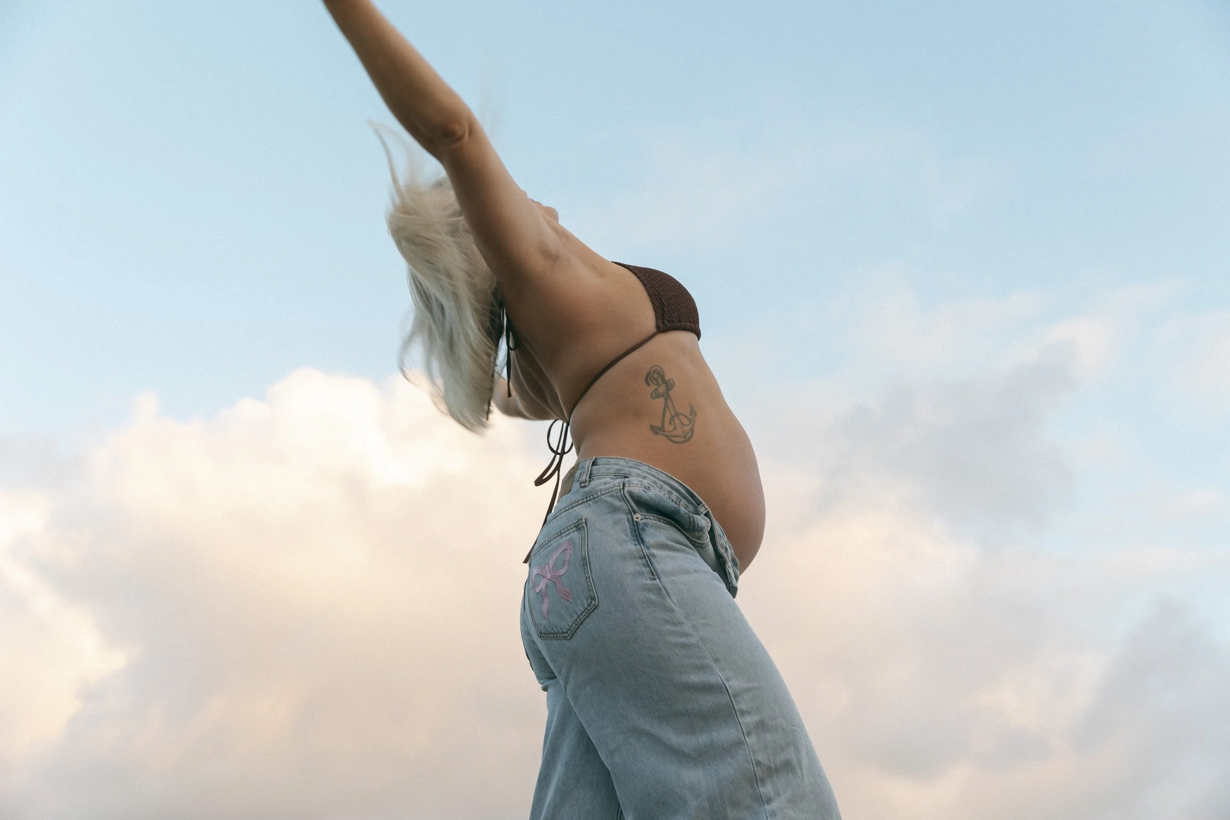 This is one of my favourite things about Gold Coast sunrise maternity sessions — that transition. You arrive in the cool, cinematic blue of early morning and by the time we're done, everything has turned to gold.