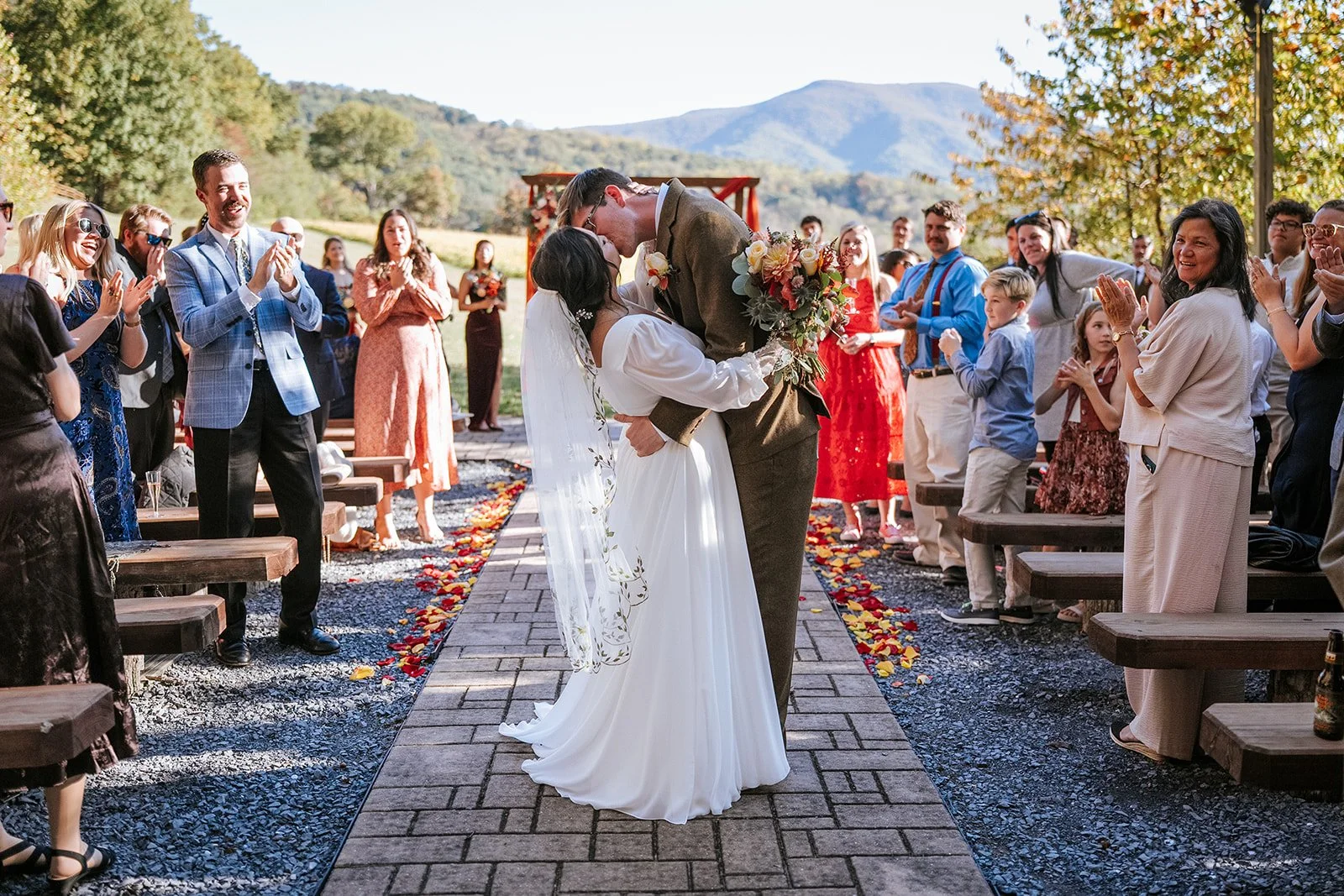 A bride and groom kiss after their fall wedding ceremony in NOVA.