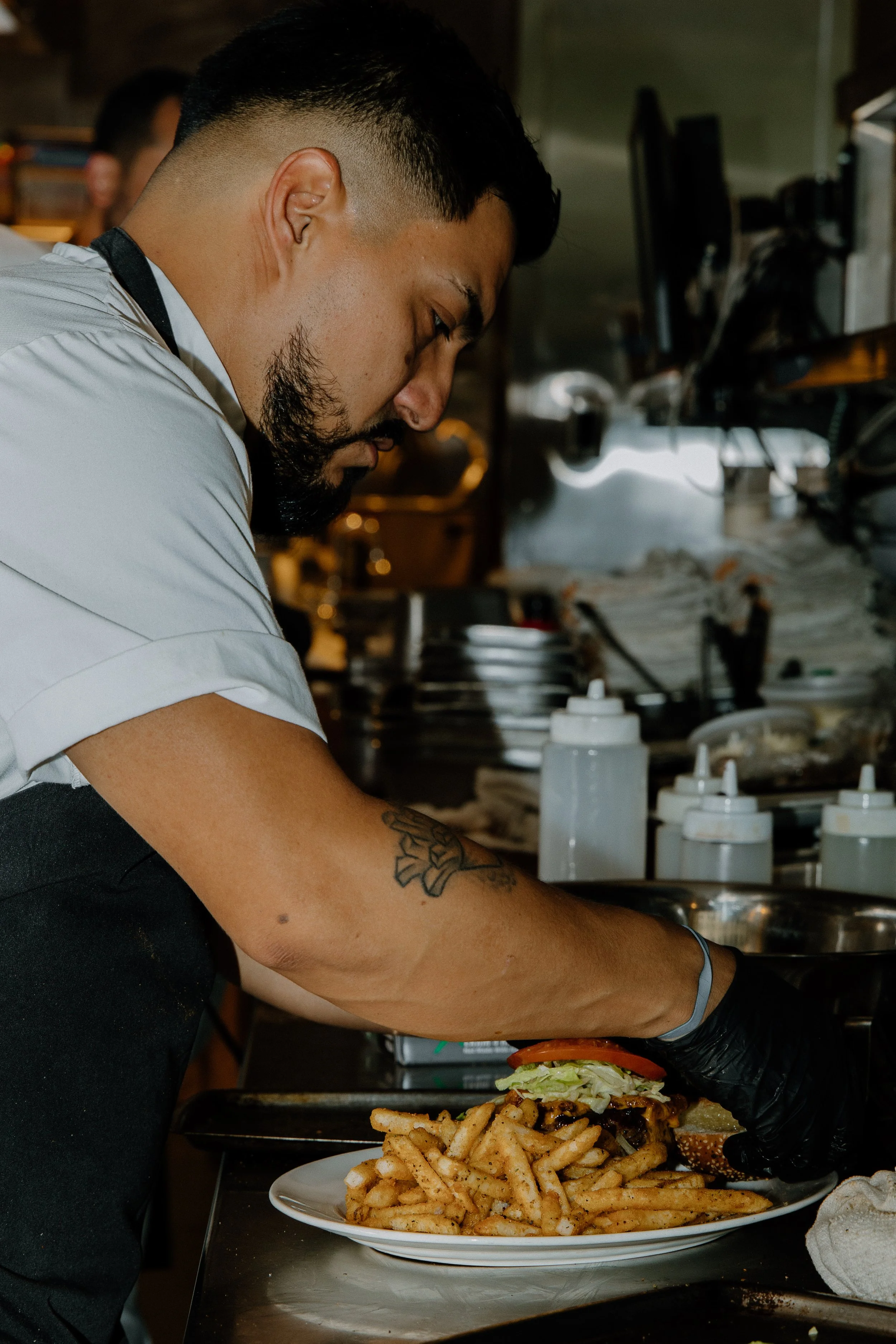 houston-restaurant-photographer-chef-plating-burger-fries-kitchen-captured-by-clarice.jpg