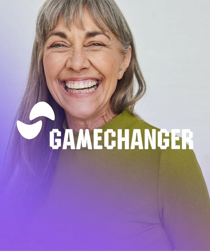 En leende äldre kvinna med grått hår i en grön tröja, mycket glädje.