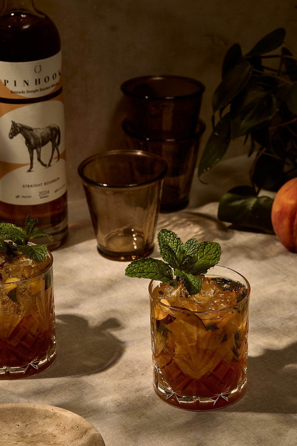 peach-bourbon-smash-cocktails-mint-garnish-bourbon-bottle.jpg