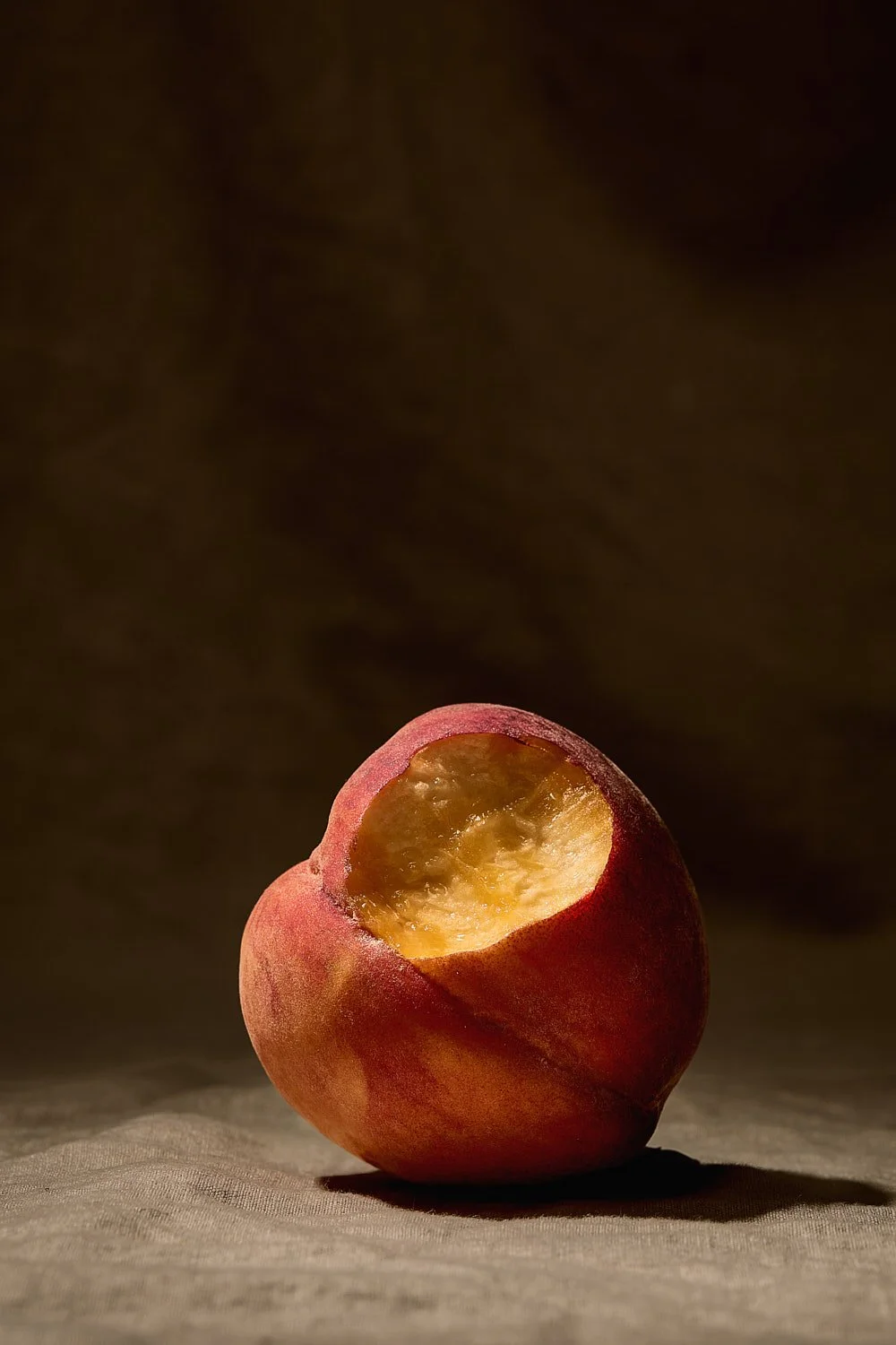 single-bitten-peach-moody-still-life-bourbon-photography.jpg