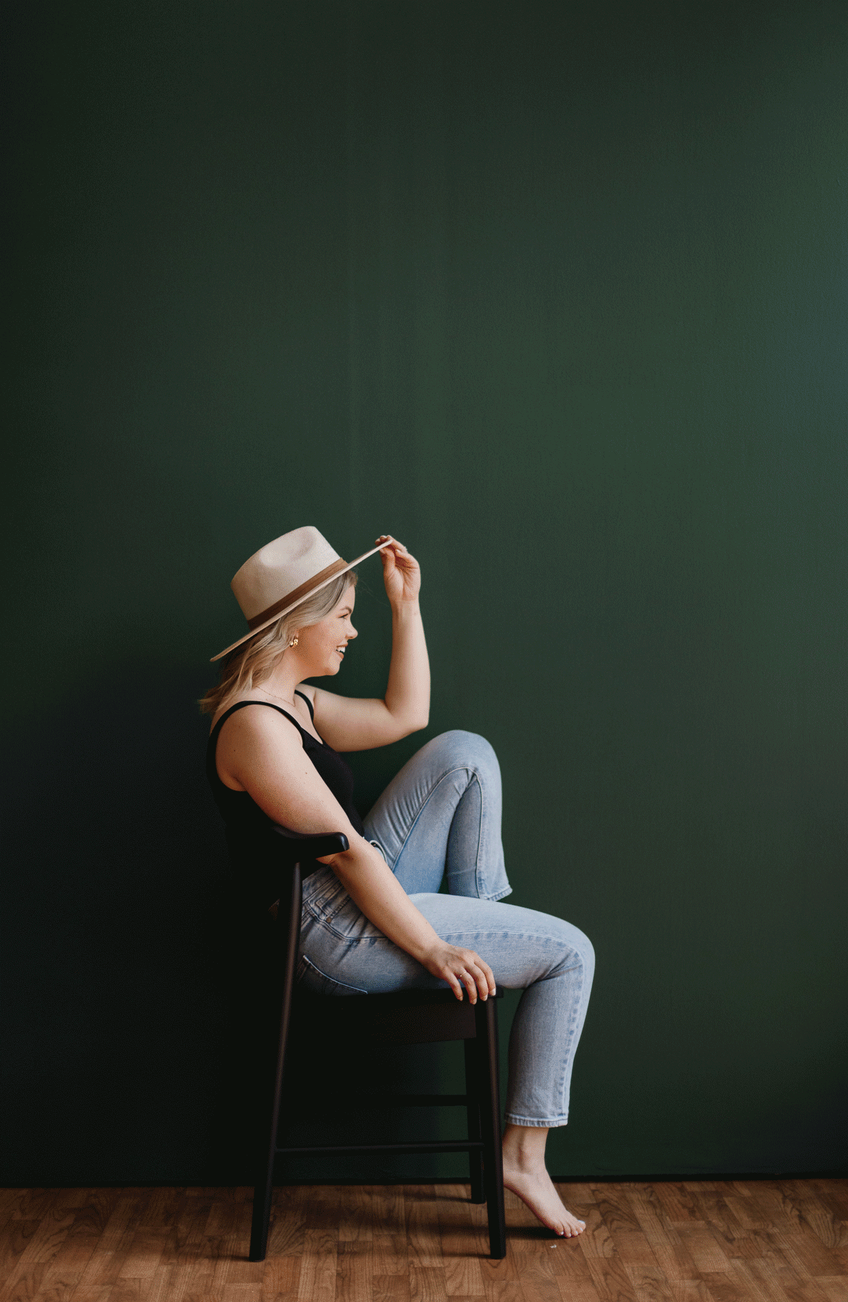 Woman laughing while sitting in a black chair