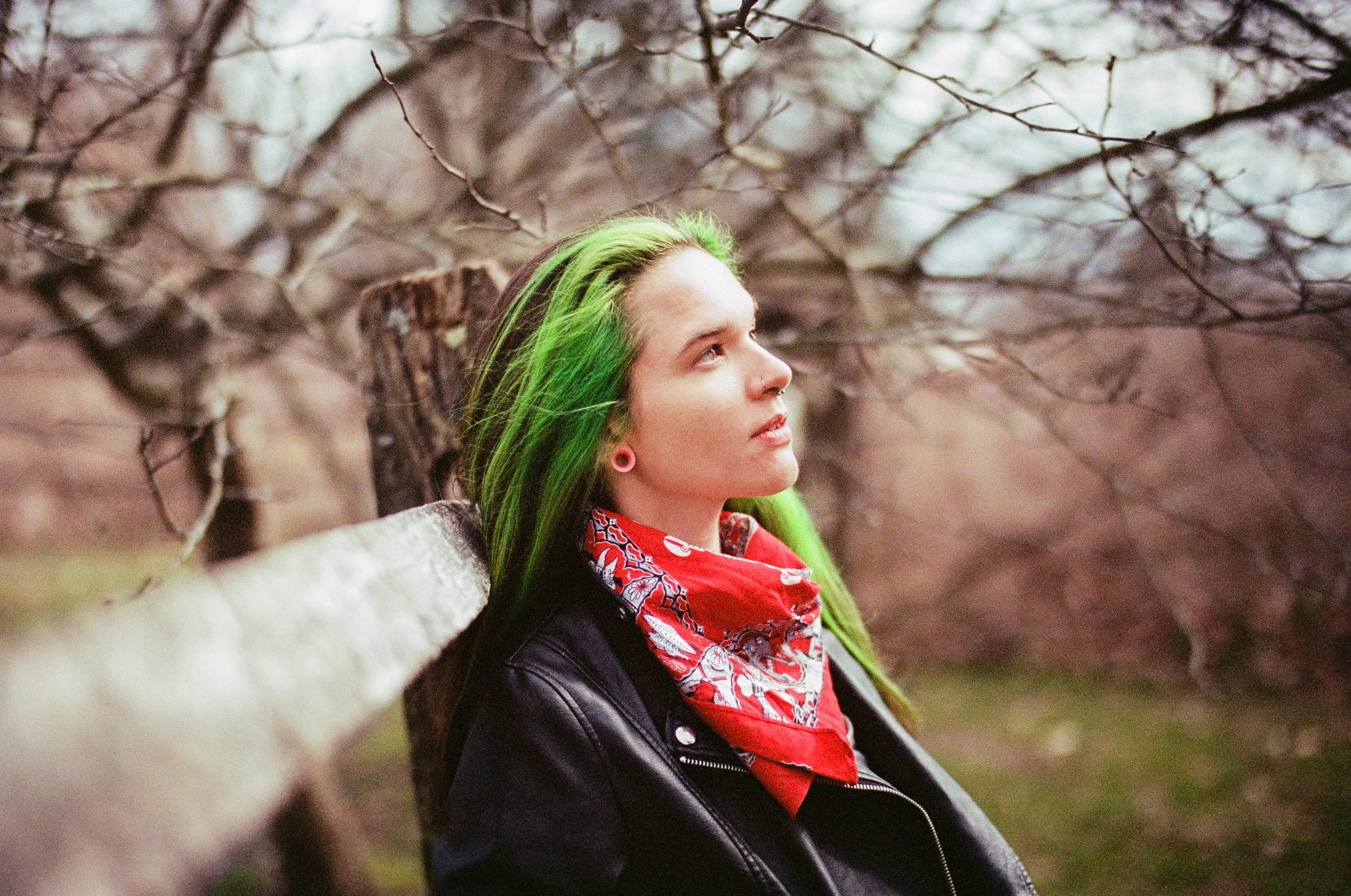Portrait brand photography by New York commercial photographer Adam Lerner - a young woman with green hair outside in a leather jacket and bandana in Connecticut