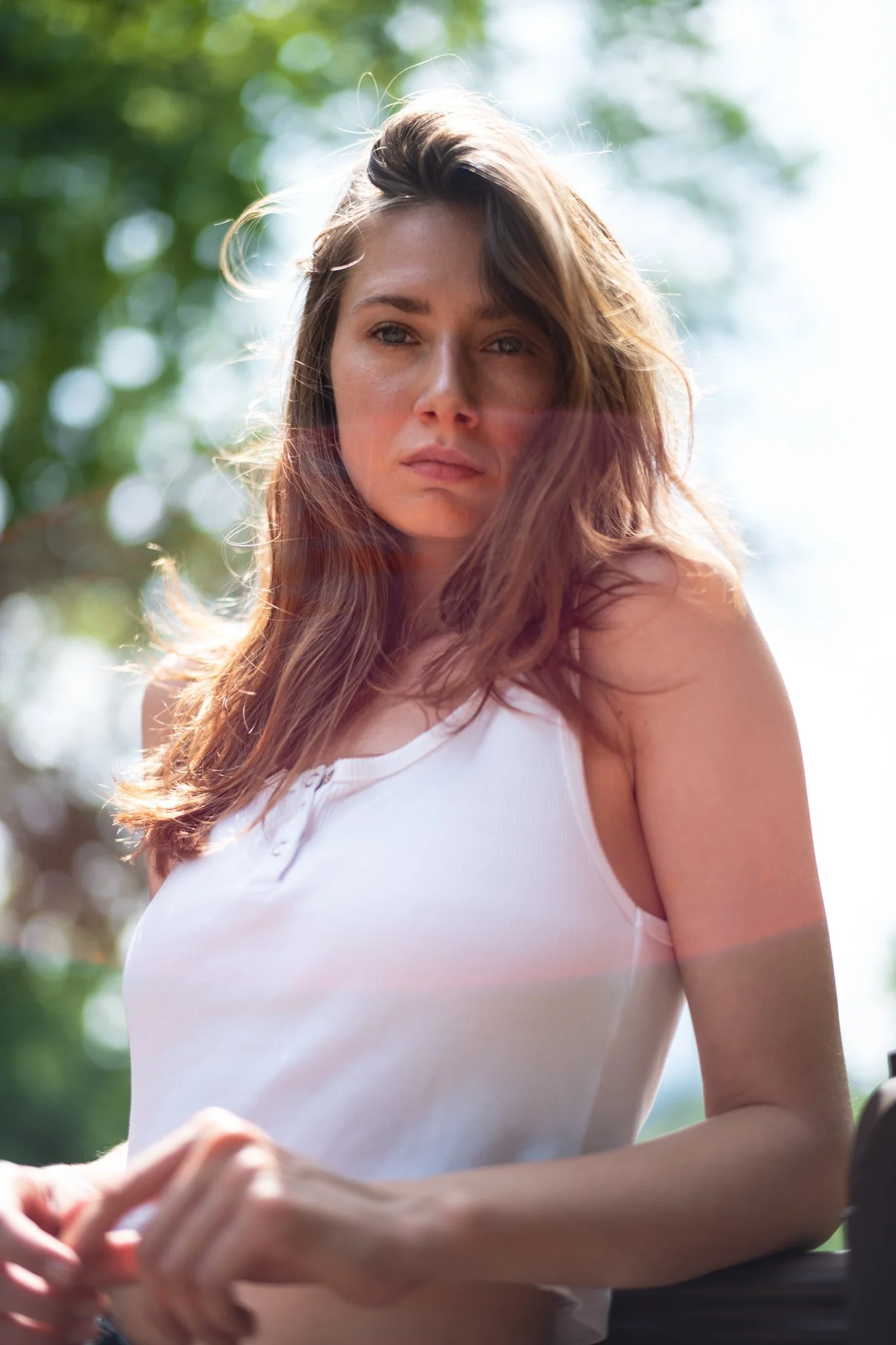 Travel brand photography by New York commercial photographer Adam Lerner - a woman in the afternoon sun in central park new york city