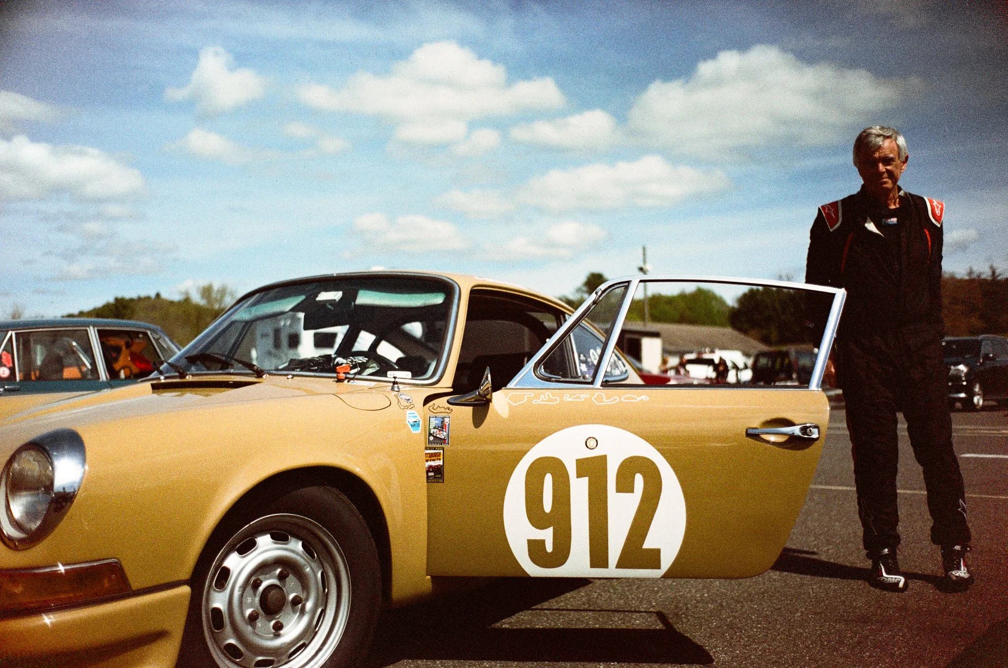 Automotive brand photography by New York commercial photographer Adam Lerner - A man with a vintage Porsche race car at Lime Rock park in Connecticut..