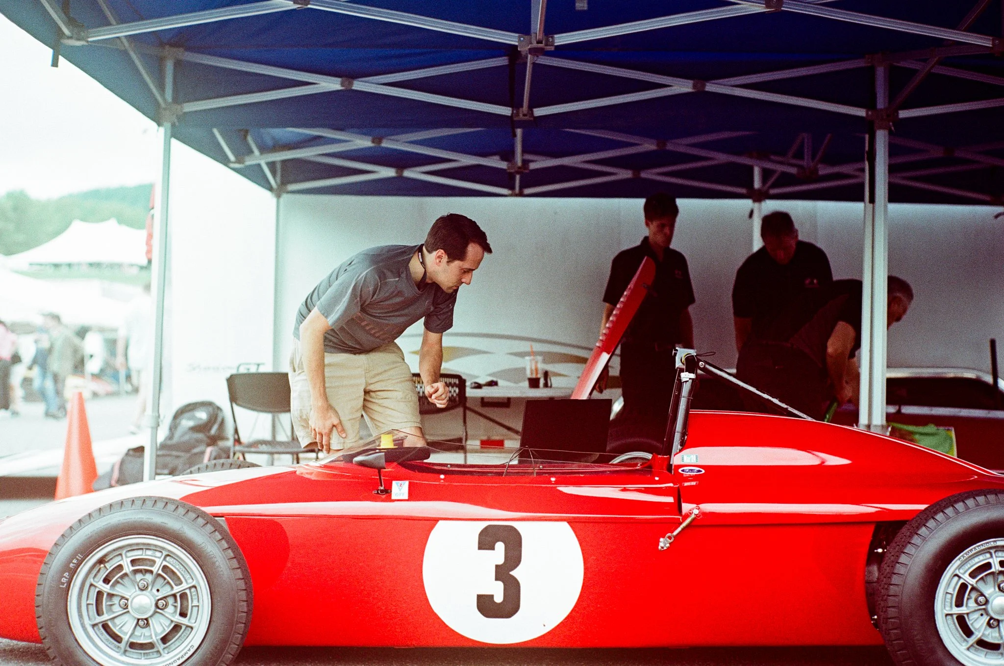 Auto brand photography by New York commercial photographer Adam Lerner - Men with a vintage race car in the paddock of Lime Rock park Connecticut