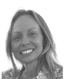 Black and white portrait of a smiling woman with wavy hair