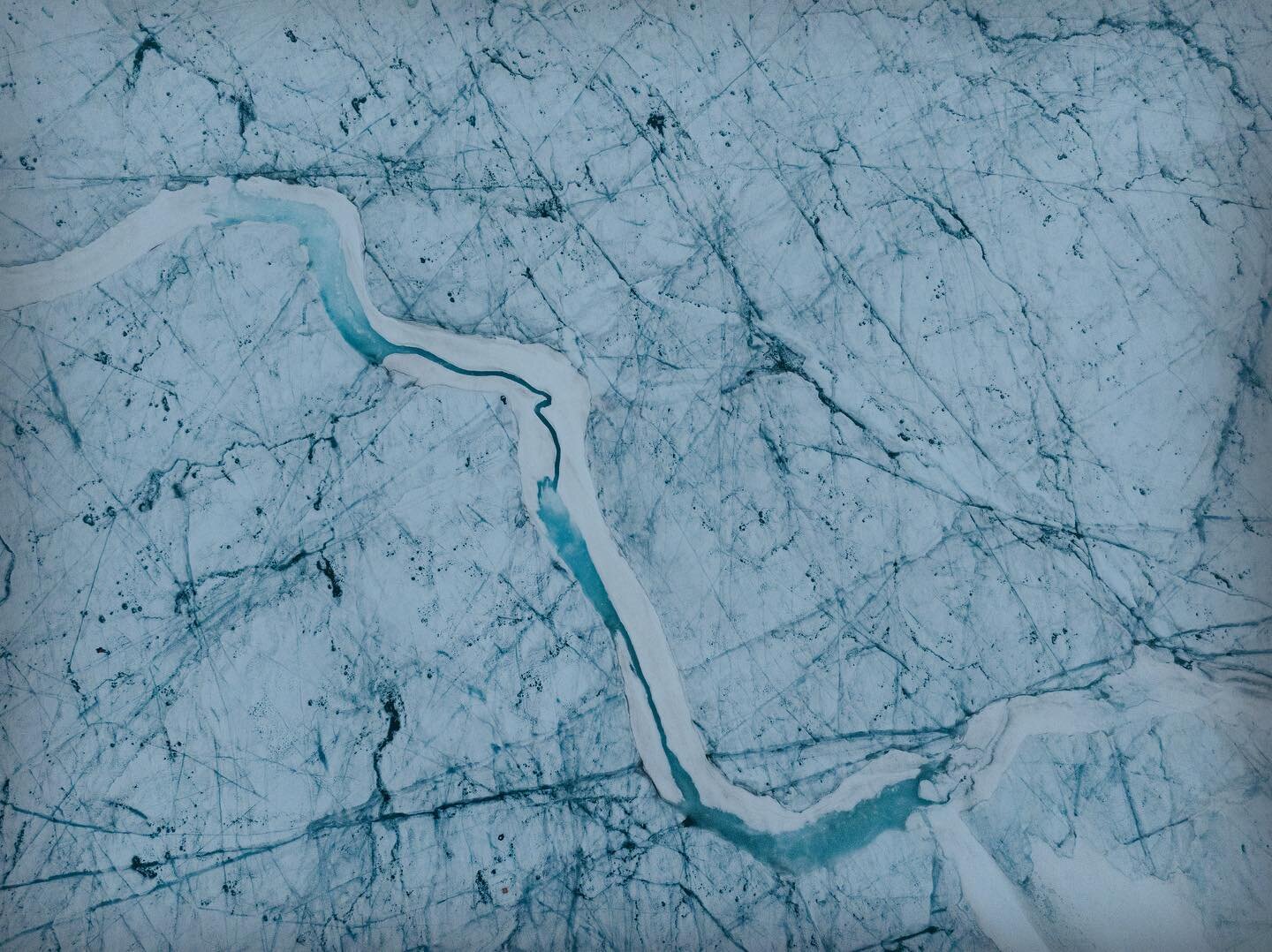 On this hot August day, let&rsquo;s dream of ice. This is from 69&deg; N, on the Greenland Ice Sheet, crisscrossed with crevasse traces and ice streams. For scale, if you look carefully at the tiny dots at the bottom you&rsquo;ll see a person and the