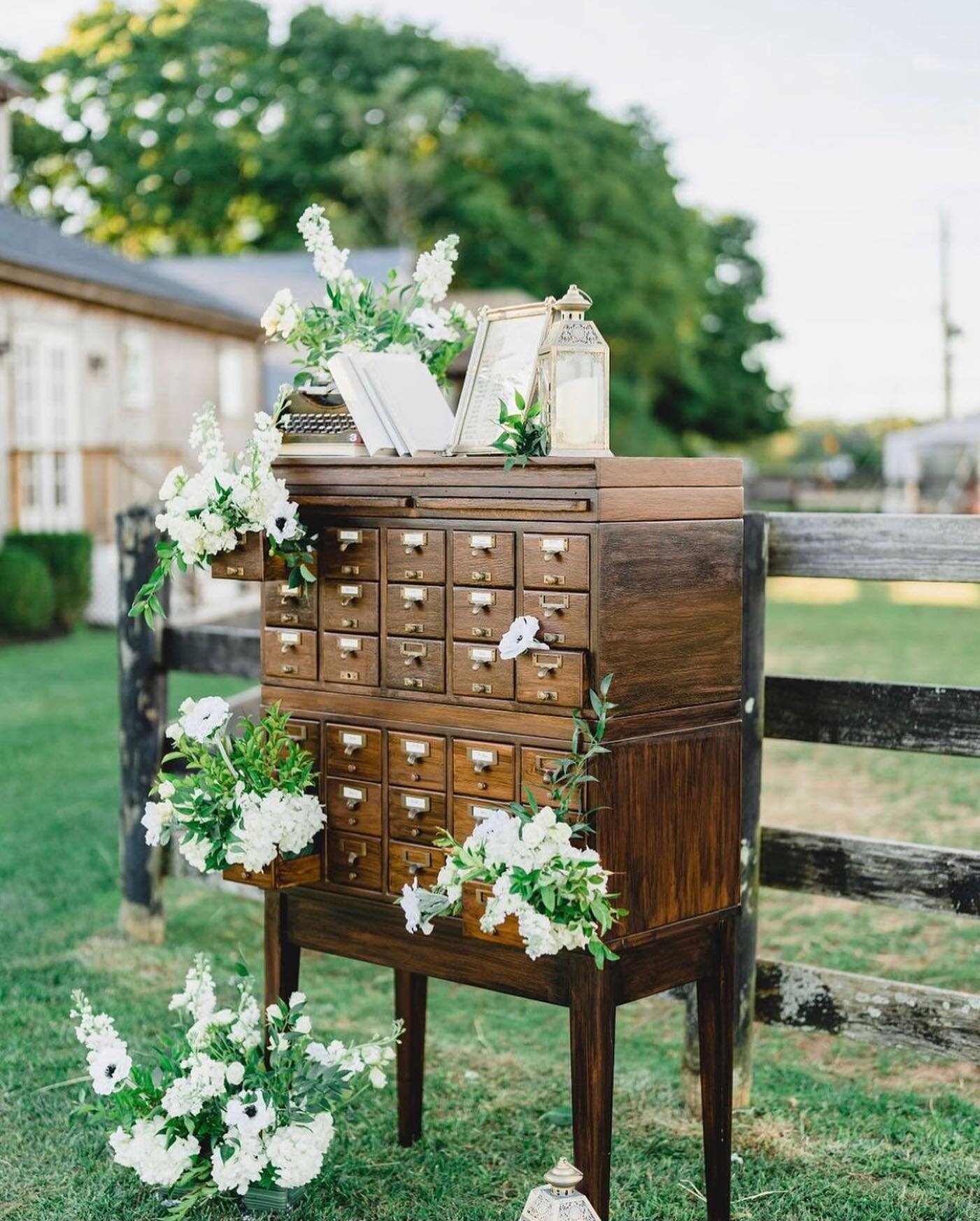 Fun fact- Our library card catalog can be separated if you don&rsquo;t need the full setup.  You can rent just one 15 drawer section with or without the table as well ☺️.

Planner: @jenniferbevents 
Bride: @elenilazarides 
Florals: @flowersbybrian 
V