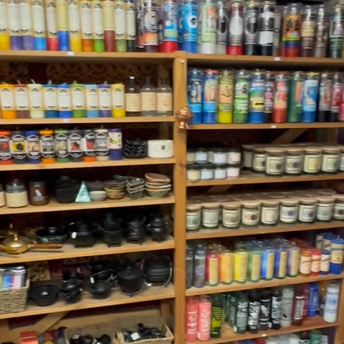 A variety of candles in varying colors, shapes and sizes line the shelves at Avalon Beyond in Orlando, Florida