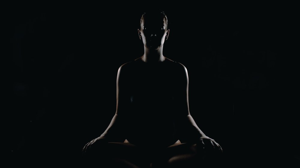 Image of woman in trance state meditating in total darkness