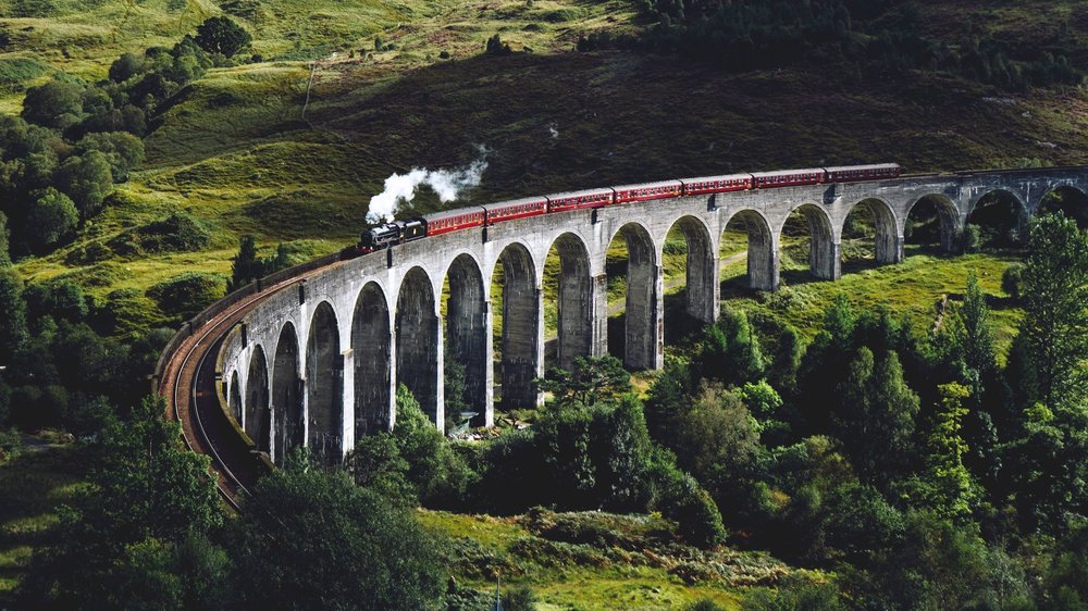 Train travels through the countryside on elevated bridge