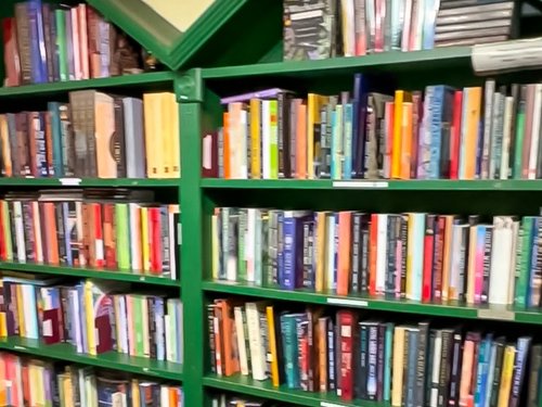 Library of books on green bookshelves at Avalon Beyond in Orlando, Florida
