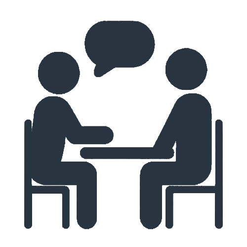Two people sitting at a table having a conversation, with a speech bubble above their heads.