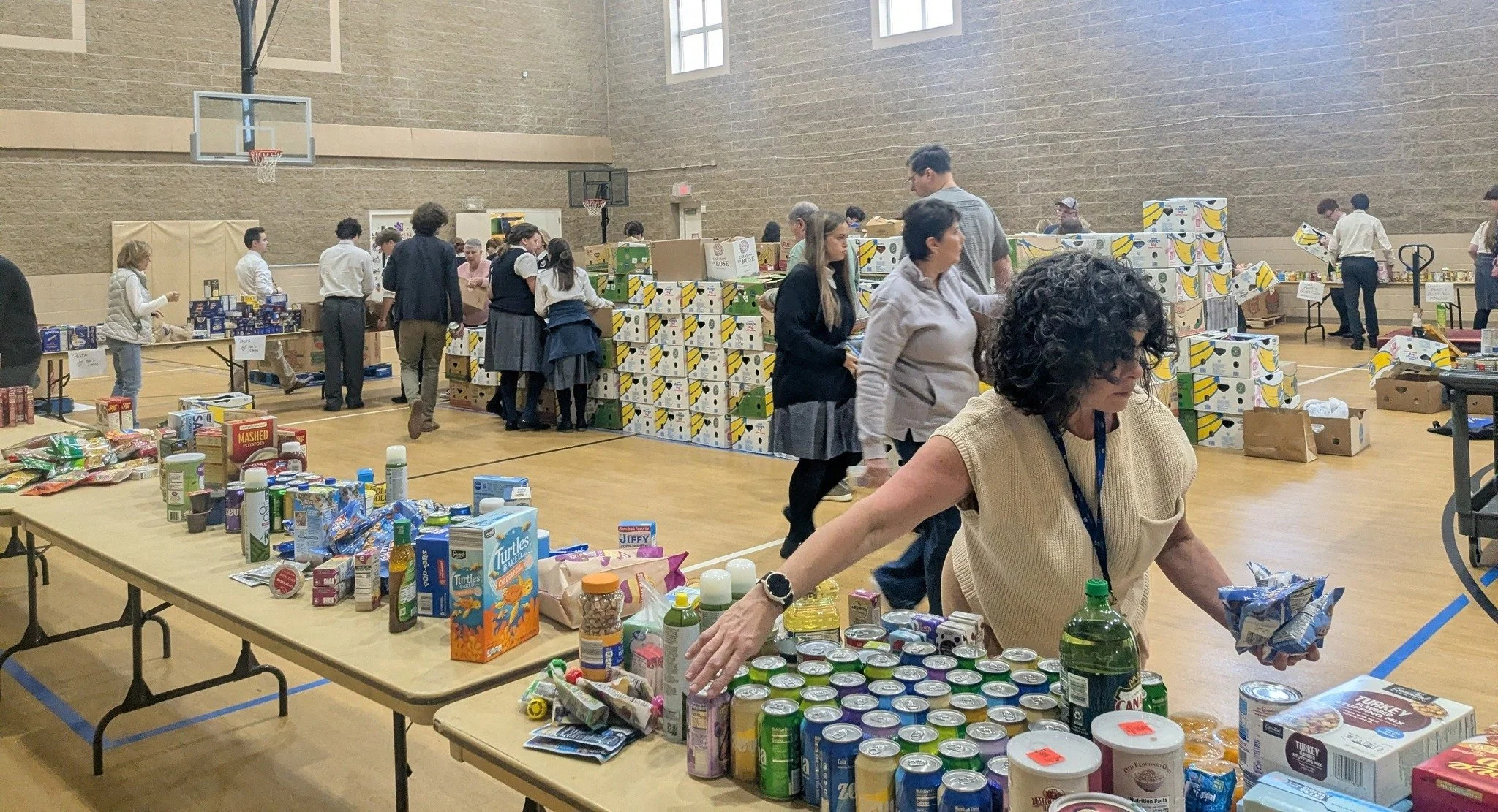 We Share the Feast with our neighbors by packing thousands of pounds of food that will be delivered in time for Thanksgiving.

Join us on November 14, 2026 at 8:00am in the gym!