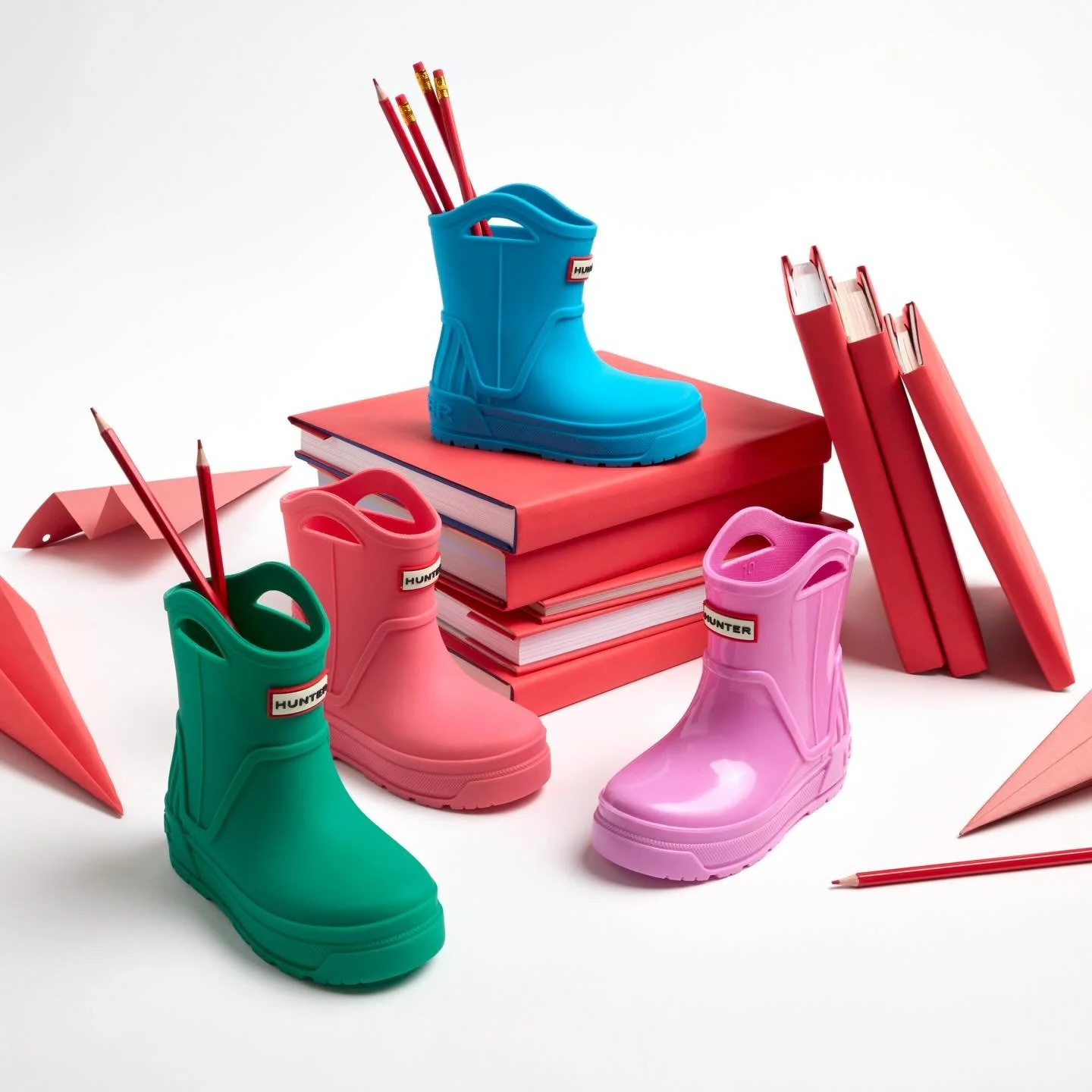 Hunter Fall 2025&mdash;Back to School Still Life. Creative directed this mini campaign to support the kids&rsquo; story. Tonal red props nod to Hunter&rsquo;s brand color while letting the boots pop against clean white.
Creative Direction: Amanda Jon
