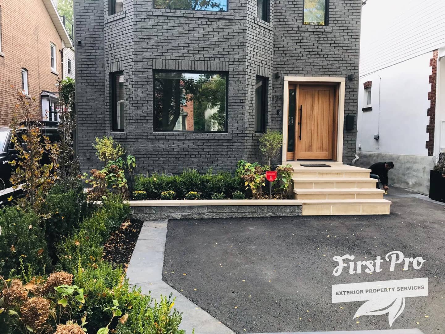 Total front home renovation to this modern looking mid-town Toronto home. 
🔨 brand new asphalt driveway with natural stone accents
🧰 new limestone front steps and raised garden, wow 👏
🌱 Front garden design and install
.
.
.
#landscapedesign #pati