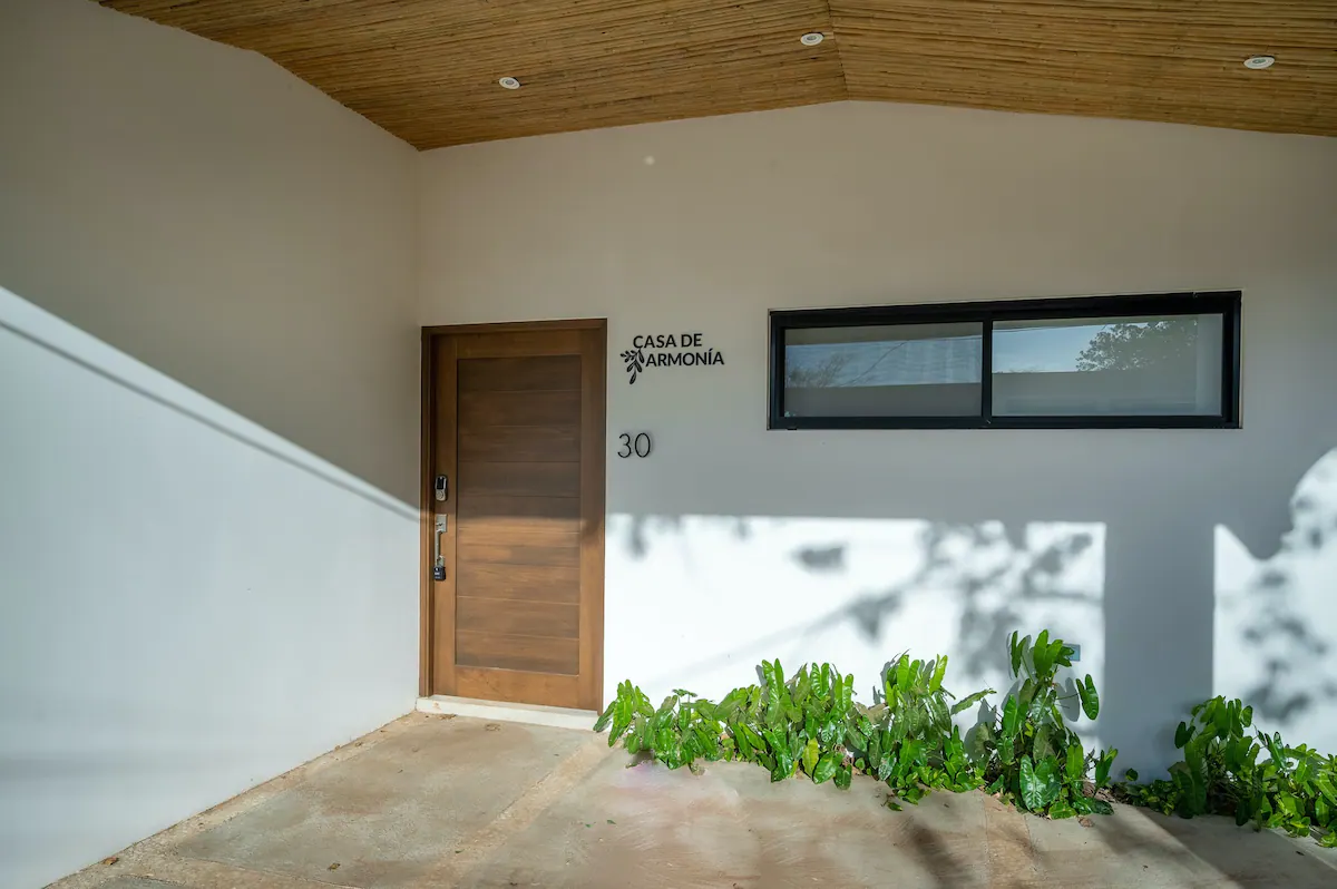 Covered garage and front entry. Casa de Armonía has covered parking for one vehicle, a side lot for another, and street parking.