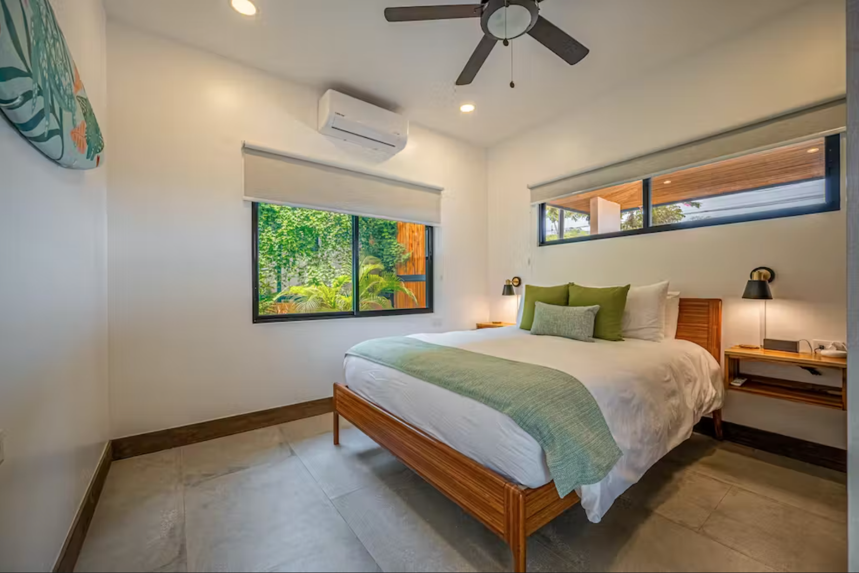 Guest Bedroom #1, with queen size bed and custom surf board art by a local artist.