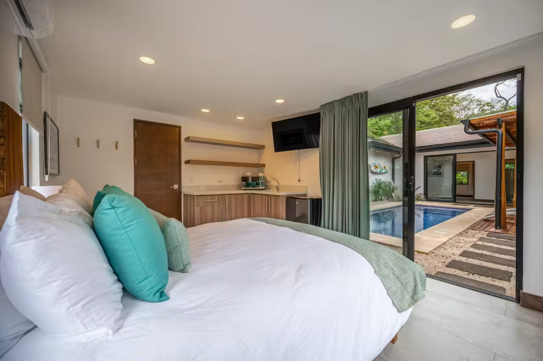 Casita kitchenette and queen bedroom with en suite bathroom.