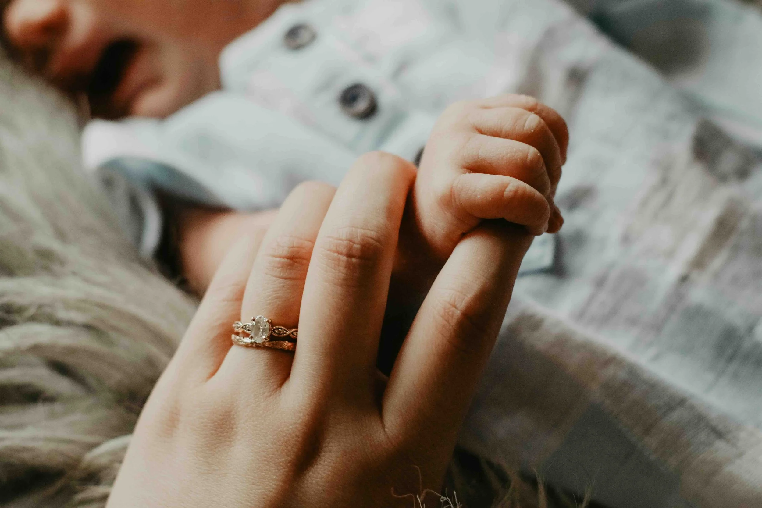mom holding newborn hand