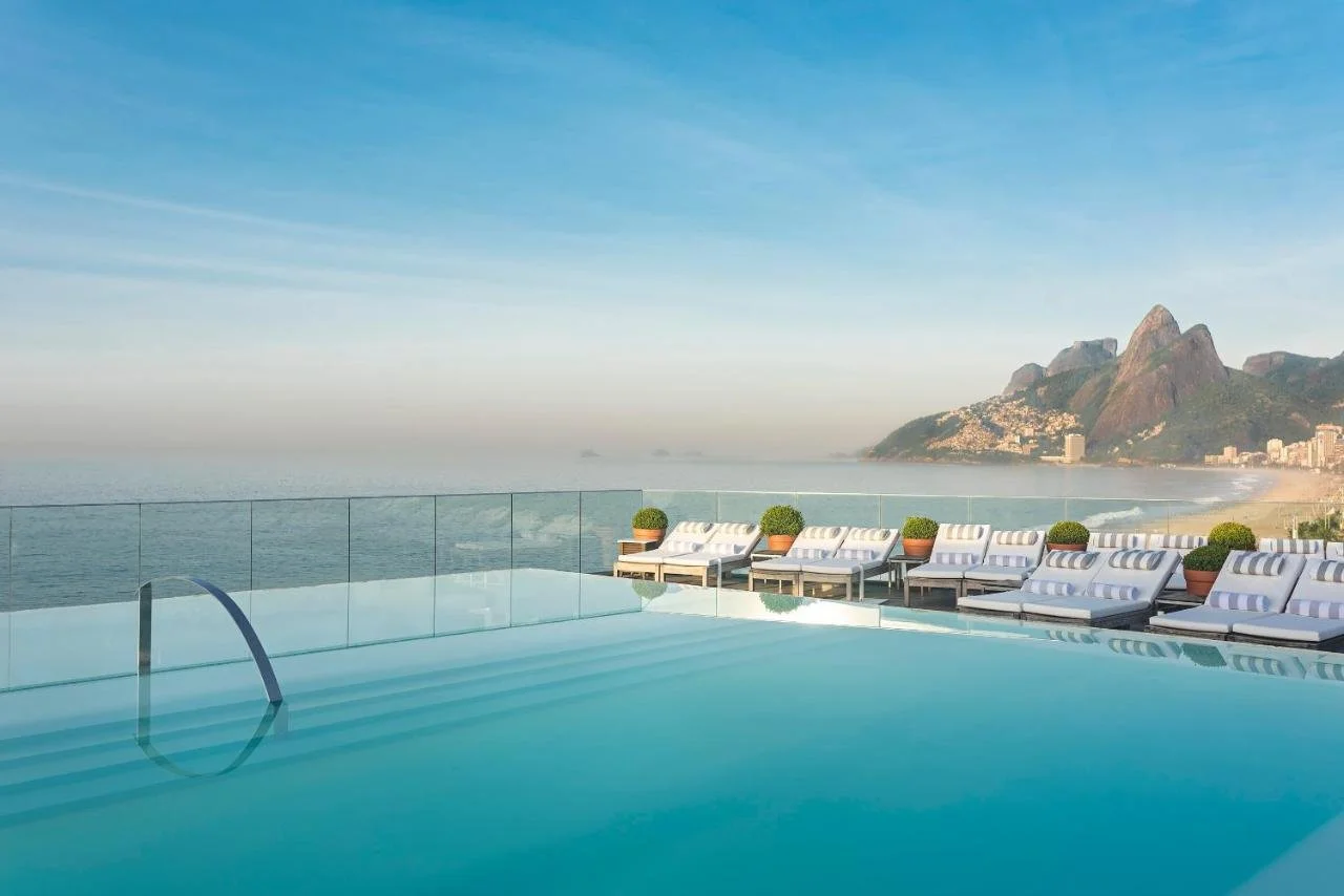 Hotel Fasano Rio de Janeiro rooftop infinity pool facing Ipanema Beach and Two Brothers Mountain at dawn