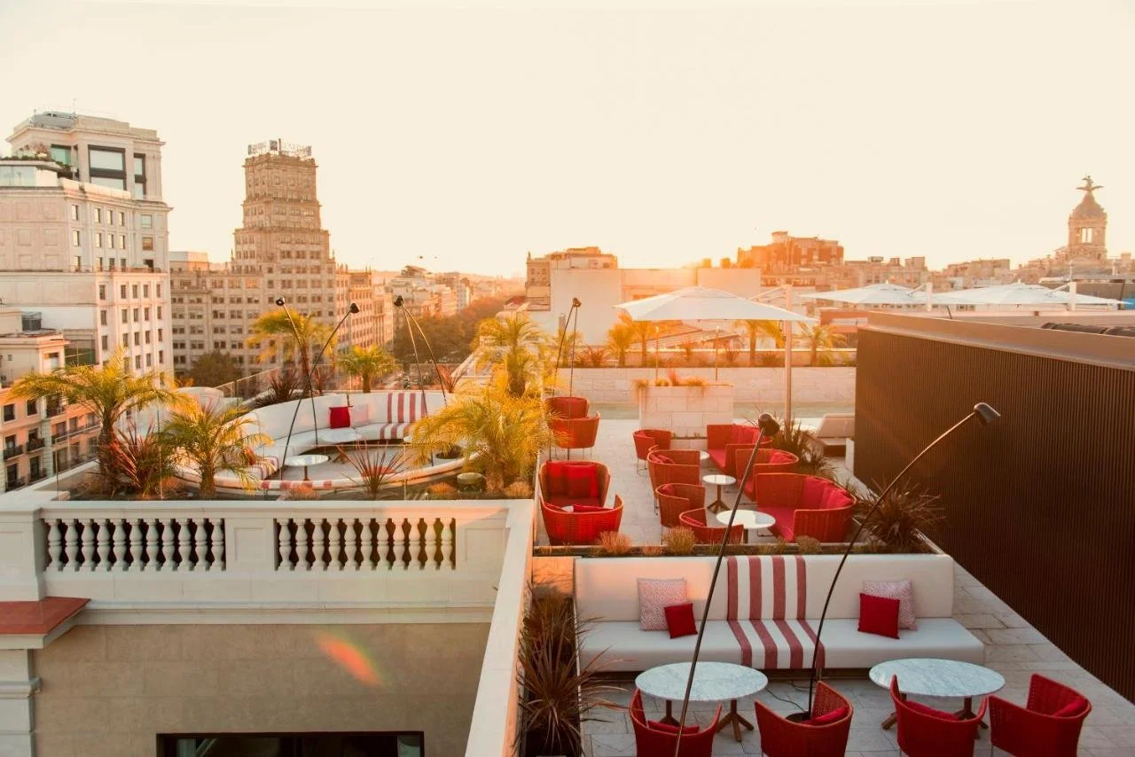Almanac Barcelona rooftop Azimuth terrace at sunset with Passeig de Gràcia avenue and Barcelona city skyline