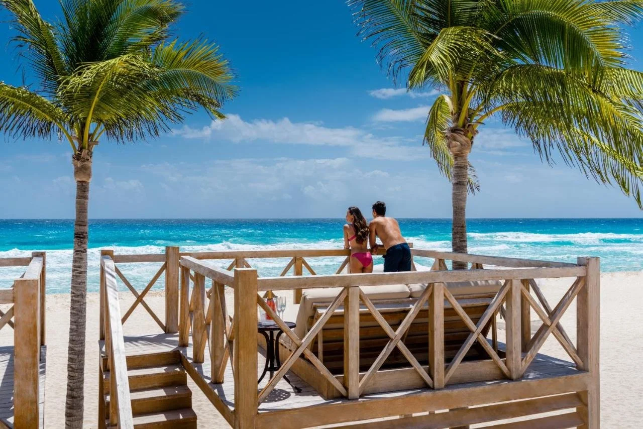 Hyatt Zilara Cancun hotel balcony with wicker seating and elevated view of Hotel Zone beach and Caribbean Sea