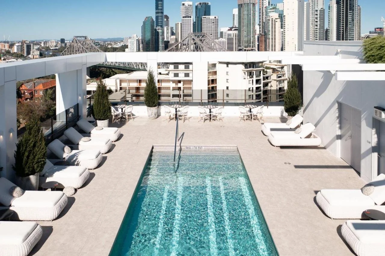 Hotel X Brisbane Fortitude Valley rooftop pool with Story Bridge and Brisbane CBD skyline