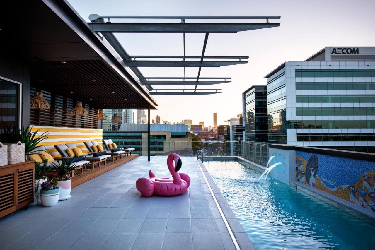 Ovolo Brisbane Fortitude Valley rooftop pool at dusk with Brisbane CBD skyline