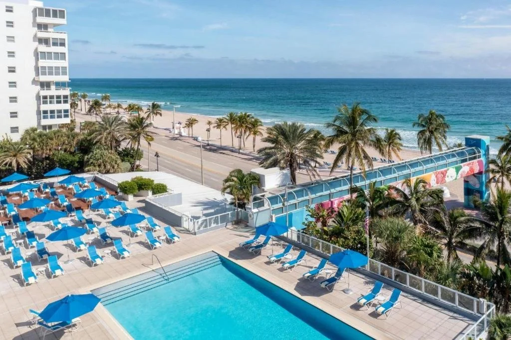 The Westin Fort Lauderdale Beach Resort pool deck and covered skywalk over A1A with Atlantic Ocean and beach beyond