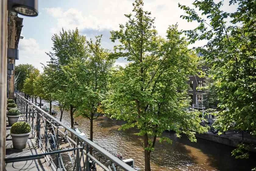 Banks Mansion Amsterdam balcony view over the Herengracht canal lined with trees and historic canal houses