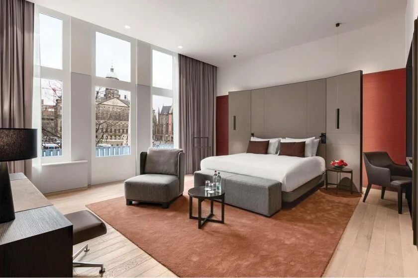 Anantara Grand Hotel Krasnapolsky Amsterdam hotel room with tall windows overlooking the Royal Palace Amsterdam facade on Dam Square