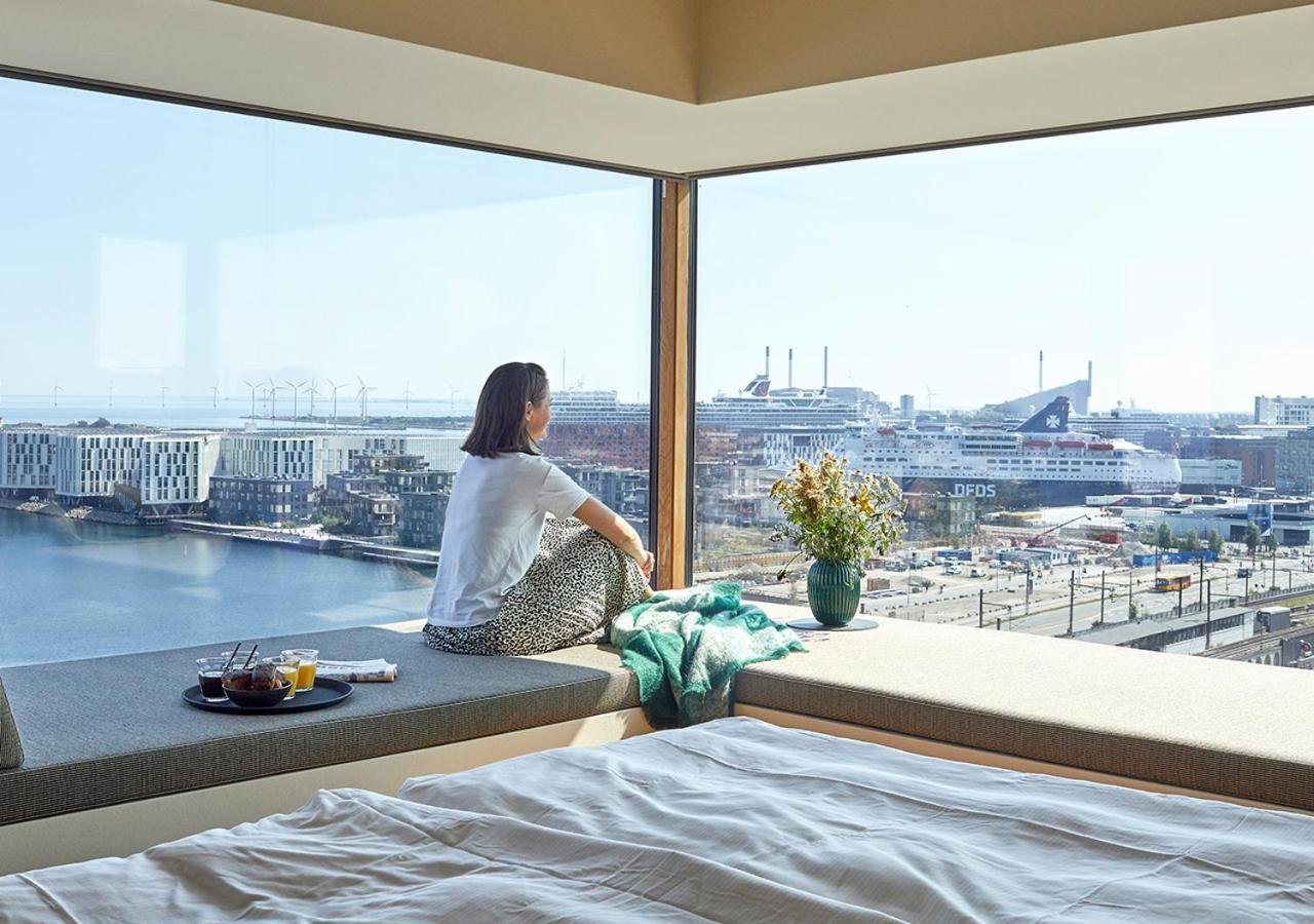 Charlottehaven Copenhagen corner room with floor-to-ceiling harbor view showing DFDS ferry, Nordhavn, and Øresund wind turbines