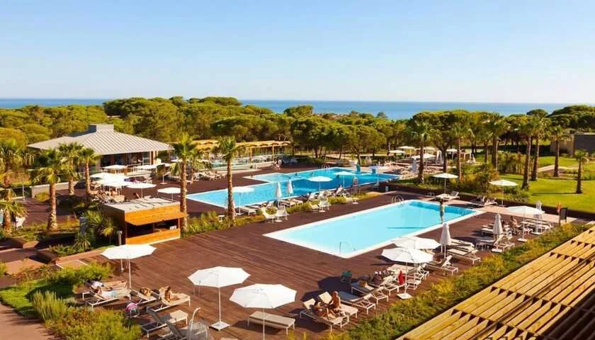 EPIC SANA Algarve Hotel Albufeira aerial view of pool deck with pine forest and Atlantic Ocean beyond