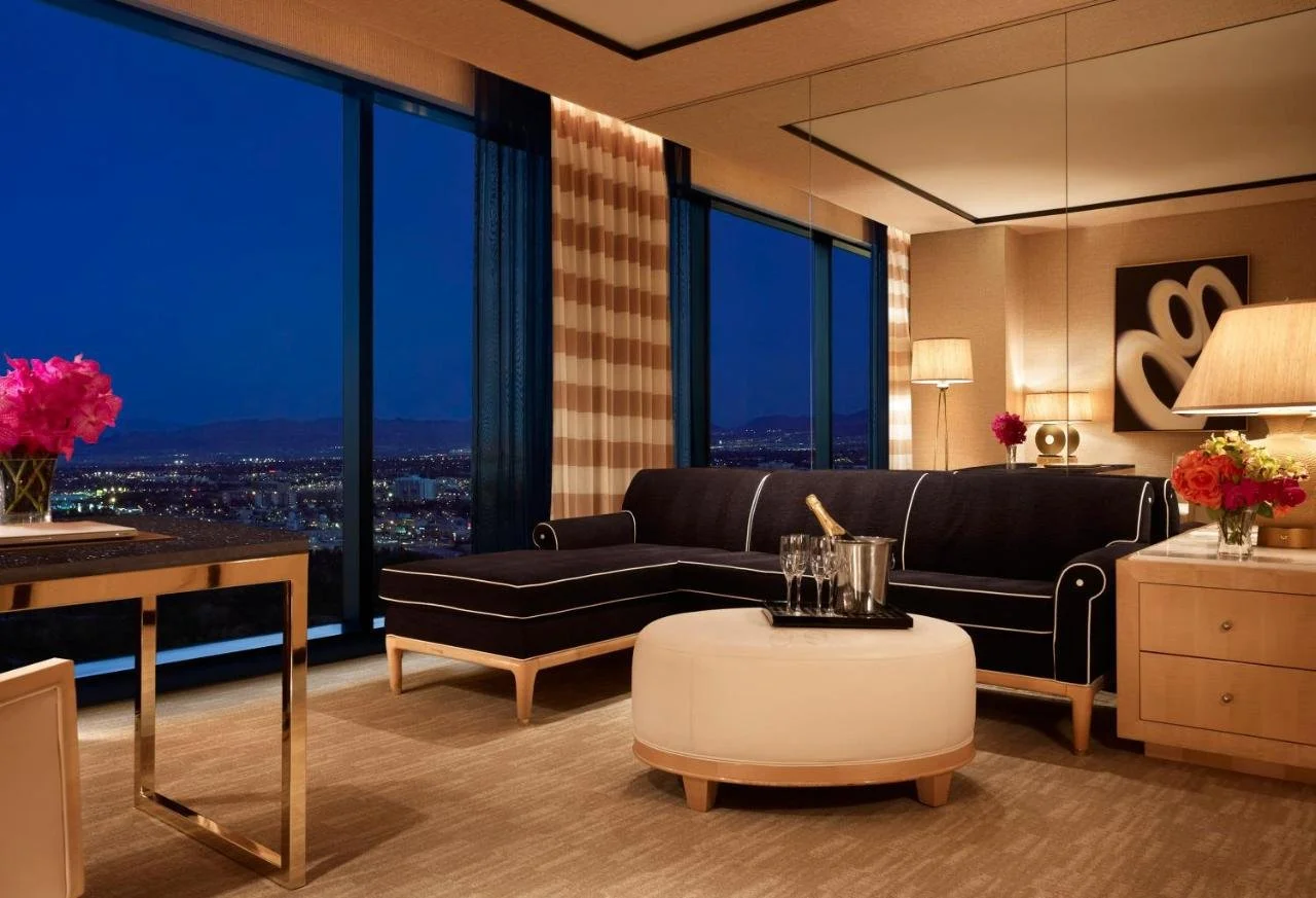 Encore at Wynn Las Vegas suite living room with floor-to-ceiling windows and panoramic city lights at night