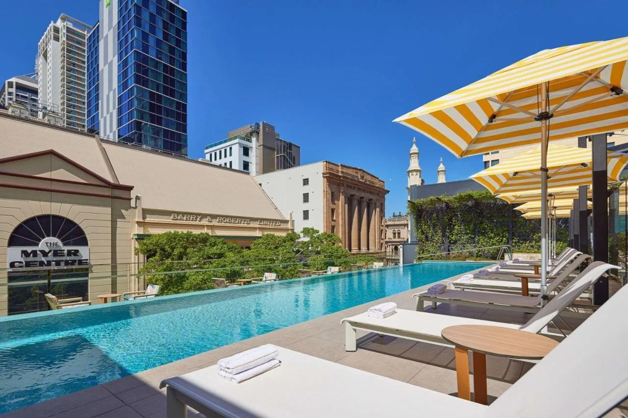 Hyatt Regency Brisbane rooftop infinity pool with Brisbane CBD heritage buildings and skyline
