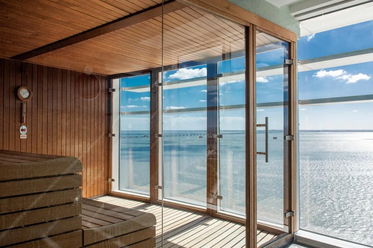 MYRIAD by SANA Hotels Lisbon SAYANNA Spa sauna on upper floor with panoramic glass wall overlooking Tagus River estuary