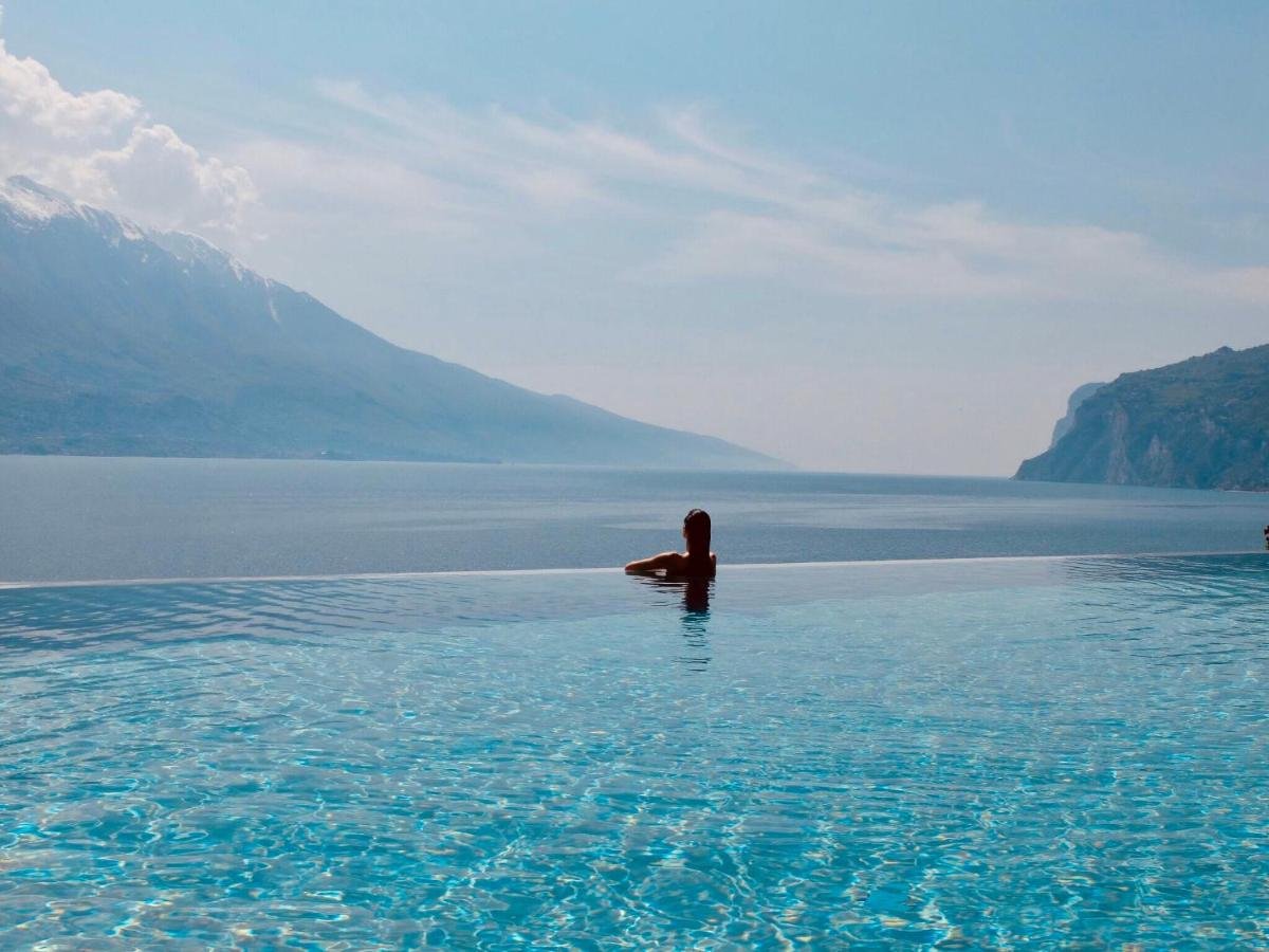 EALA My Lakeside Dream Limone sul Garda woman enjoys spectacular view of the lake and mountains from an infinity pool