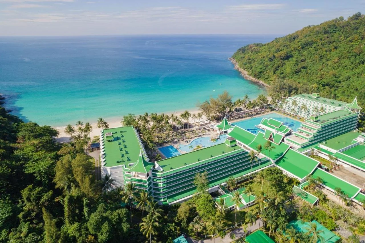 Le Meridien Phuket Beach Resort aerial view with Thai-style green roofs private Karon Noi beach and Andaman Sea